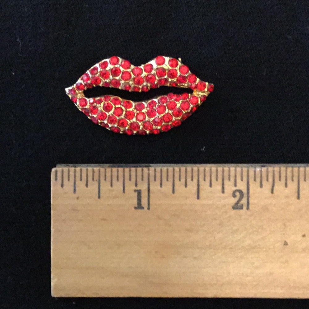Red rhinestone lips pin.